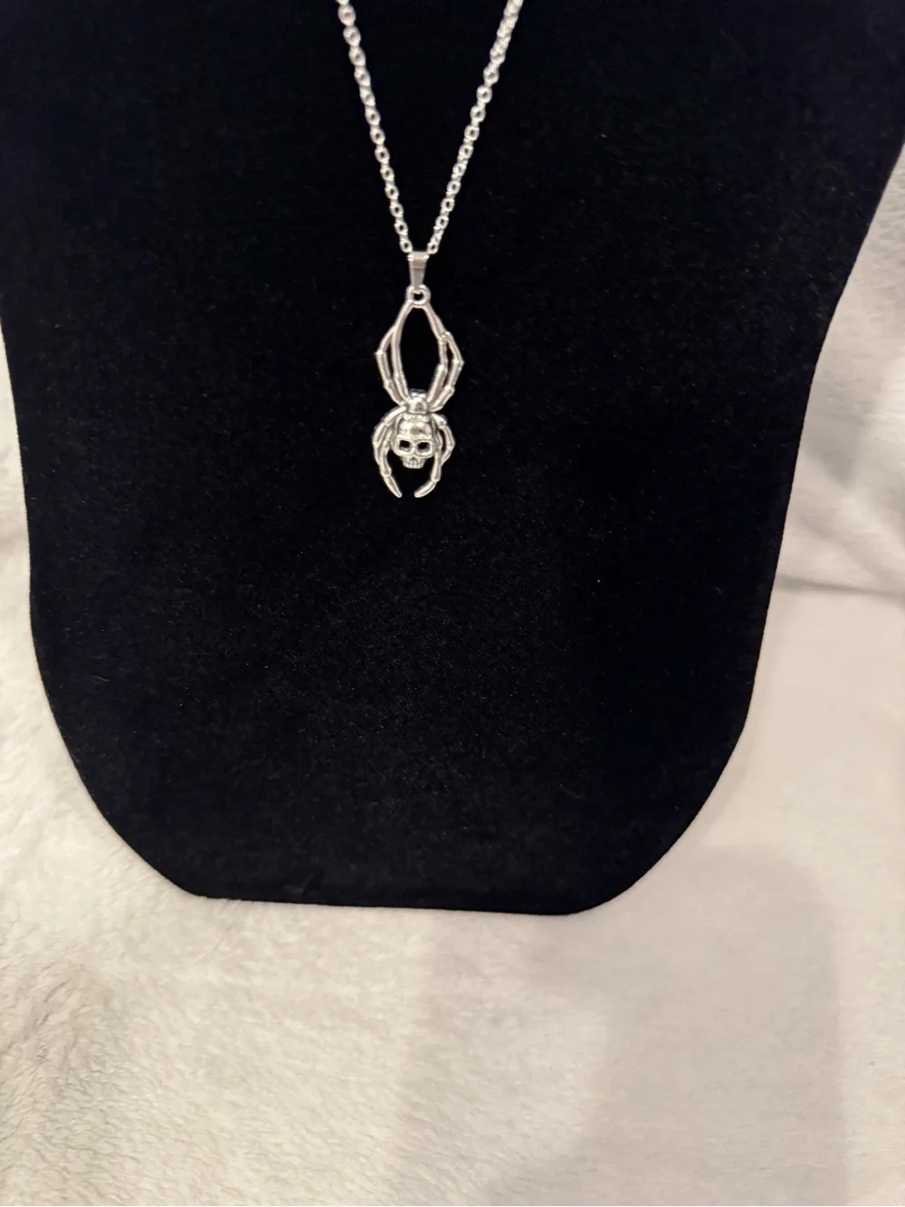 Silver spider pendant necklace with skull design